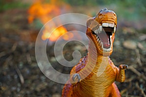 Dinosaurs Tyrannosaurus rex model running away from forest fire