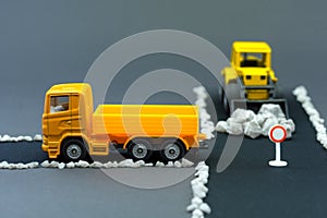 Diorama road construction with yellow construction machinery models