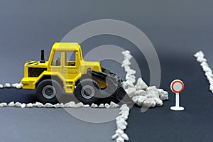 Diorama road construction with yellow construction machinery models