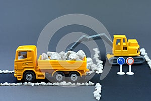 Diorama road construction with yellow construction machinery models