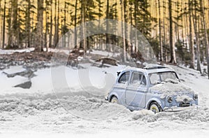Diorama - Vintage car on snow-covered mountain road photo