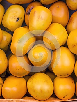 Diospyros Kaki (caqui) fruit in a market in Peru. photo
