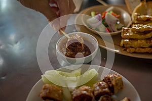 Dip the Deep Fried Crab and chicken meat roll Hoi Jo in sauce