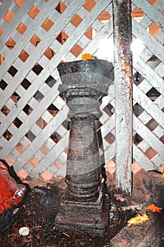 A Dipa Stambha Made of Stone Kept in a Old Indian Temple photo