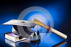 Graduation hat, Diploma and book