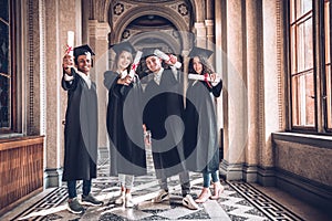 Diplomas in diversity!Shot of a diverse group of university students holding their diplomas