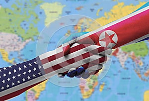 Diplomatic handshake between countries: flags of United States and North Korea overprinted the two hands