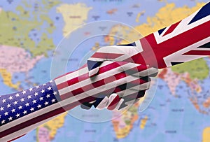 Diplomatic handshake between countries: flags of United States and United Kingdom overprinted the two hands