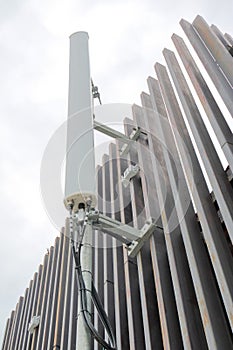 Dipole antenna for telecommunications contrasting white sky back