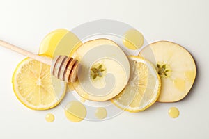 Dipper, honey, apple and lemon slices on white background