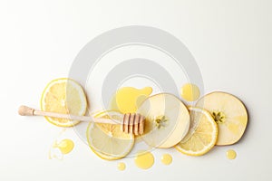 Dipper, honey, apple and lemon slices on white background