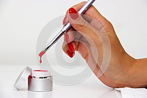Dipping the brush in nail polishes photo