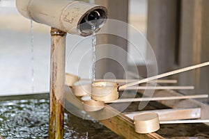 Dipping cups for cleansing ceremony, hand wash pavilion before enter the shrine gate at Meiji jingu in Tokyo, Japan. religion and