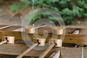 Dipping cups for cleansing ceremony, hand wash pavilion before enter the shrine gate at Meiji jingu in Tokyo, Japan. religion and