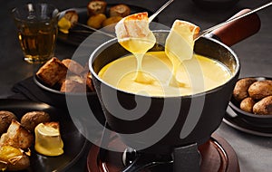 Dipping into a gourmet cheese fondue photo