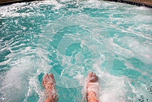 Dipping toes in warm bubbly hot tub