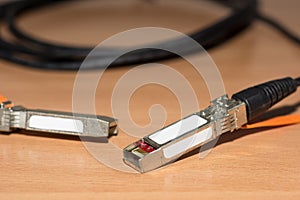 Direct attach copper cable for 10 Gb fast speed internet and network on wooden desk