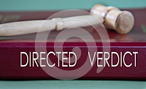 DIRECTED VERDICT - words on a burgundy folder on the background of a judge\'s gavel photo