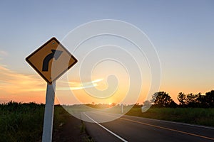 Direction sign- right turn warning on sunset background with blank for text