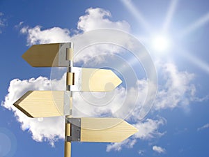 Direction sign under sun