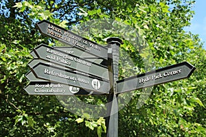 Direction signals in Hyde Park in the city London in spring.