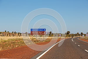 Direction signs on a road in Yulara, Ayers Rock, Red Center, Australia