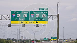 Direction signs to Houston and San Jose on the highway