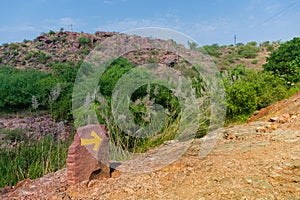 Direction on Welded tuff, massive volcanic pink rocks of Rao Jodha Desert Rock Park, Jodhpur, Rajasthan, India.