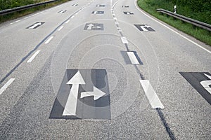 Directional arrows sign printed asphalt empty highway freeway