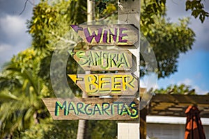 Directional Beach Sign Pointing to Wine, Sangria, Beers and Margaritas.