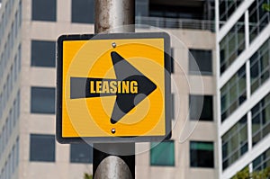 Directional sign with conceptual message LEASING