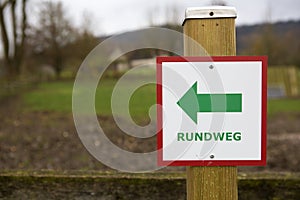 Directional sign with the German text `Rundweg` which translates into `Circular walk` in English language photo