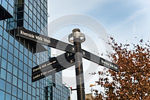 Directional Sign on a Riverside Footpath in Autumn