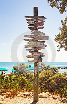 Directional signpost on the southernmost point of USA- Key West, Fort Zachary Taylor Historic State Park tropical sandy beach