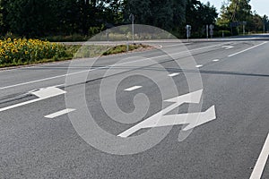 Directional signs with arrows on asphalt road