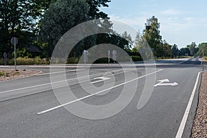 Directional signs with arrows on asphalt road