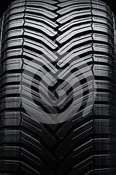 directional tire protector close-up, black rubber background photo