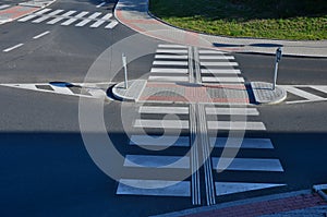 directionally divided lanes at intersection. crossing has a raised safety