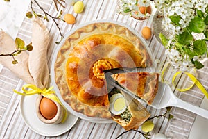 Directly above Easter table, with colored eggs, flowers, Savory Easter pie,