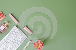 Directly above of office table desk with keyborad on green background