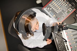 Directly Above Shot Of Radio Jockey Using Microphone And Headpho