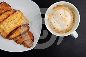 Directly above view of Franzbrotchen pastry and cup of coffee