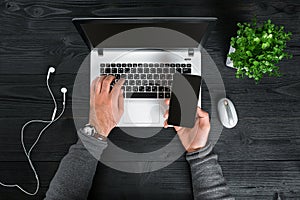 Directly above view of human hands typing on laptop.