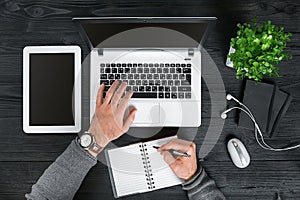 Directly above view of human hands typing on laptop.