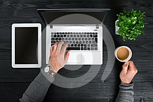 Directly above view of human hands typing on laptop.