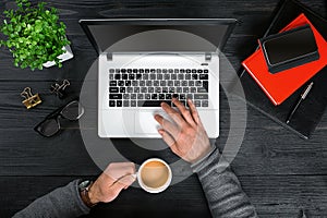 Directly above view of human hands typing on laptop.