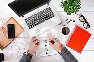 Directly above view of human hands typing on laptop.