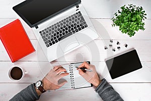 Directly above view of human hands typing on laptop.