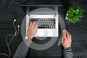 Directly above view of human hands typing on laptop.