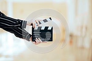 Director Holding a Film Clapper Board in a Museum